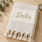 Folded beige diamond towel with Shelby embroidery